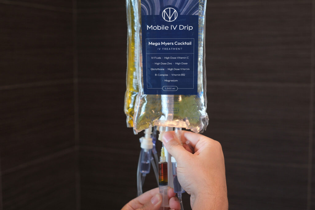 Hands preparing Mobile IV Drip for treatment