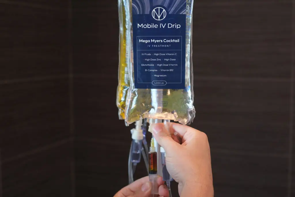 Hands preparing Mobile IV Drip for treatment