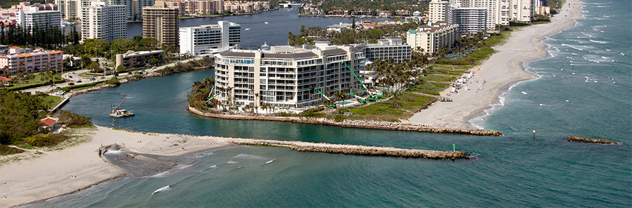 Coastal cityscape with beachfront and high-rise buildings.