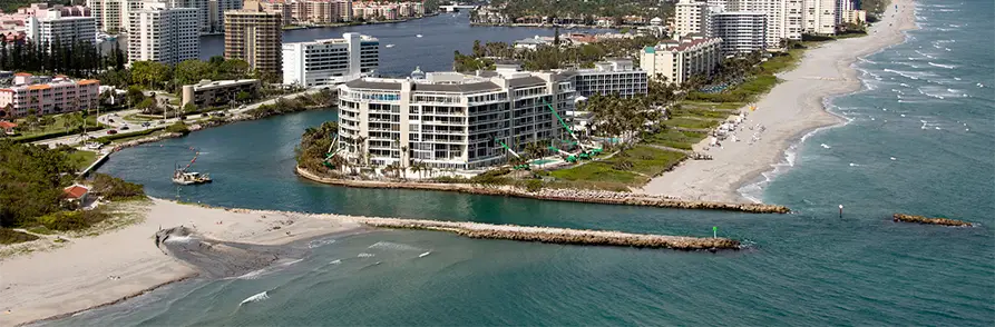 Coastal cityscape with beachfront and high-rise buildings.
