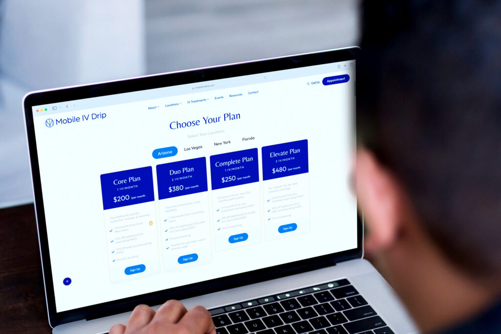 Person selecting subscription plan on laptop screen.