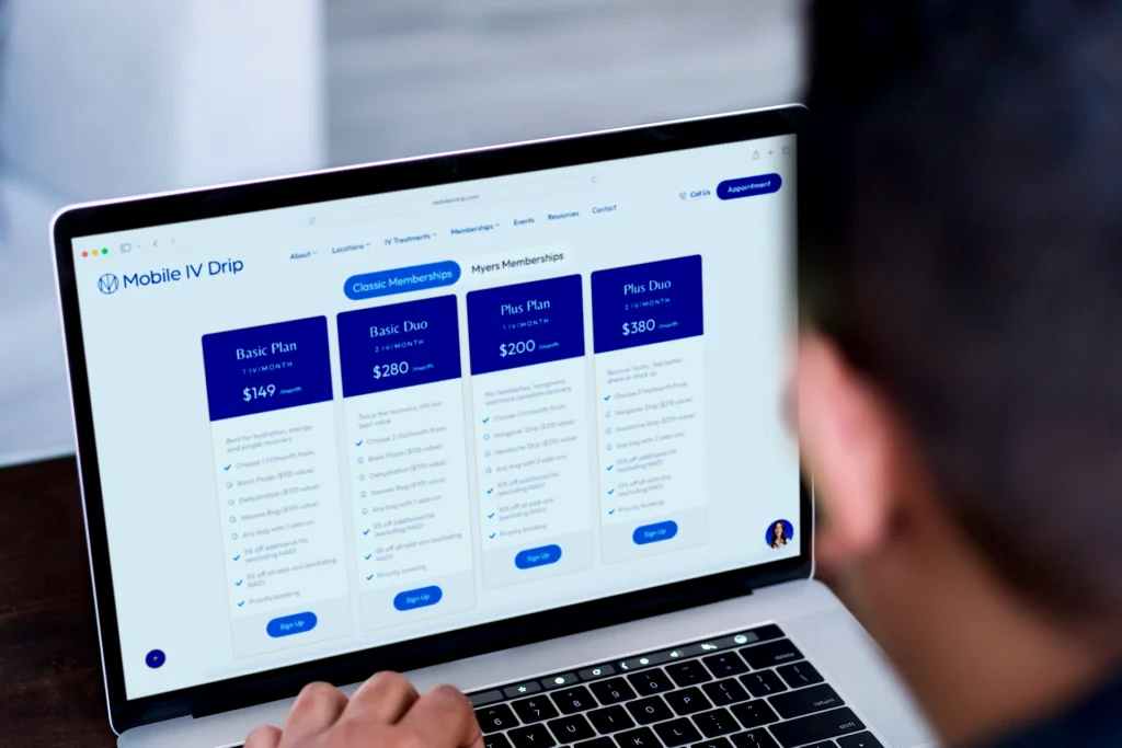 Person selecting subscription plan on laptop screen.