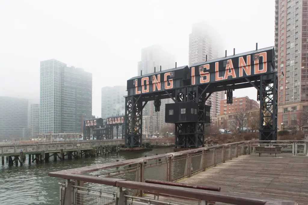 Misty view of Long Island sign with cityscape.