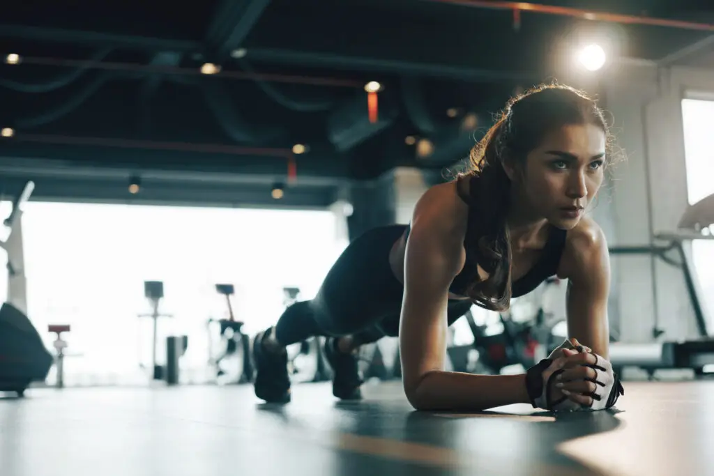 Woman planking at gym for fitness training