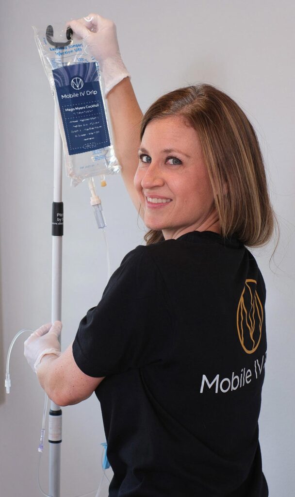 Happy nurse holding Mobile IV Drip bag