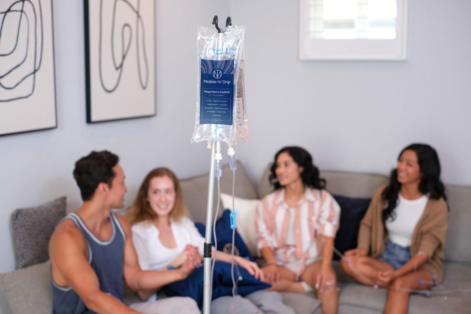 Group relaxing with mobile IV drip therapy at home.