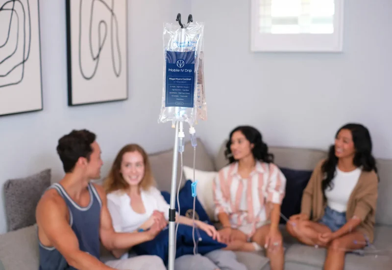 Group relaxing with mobile IV drip therapy at home.