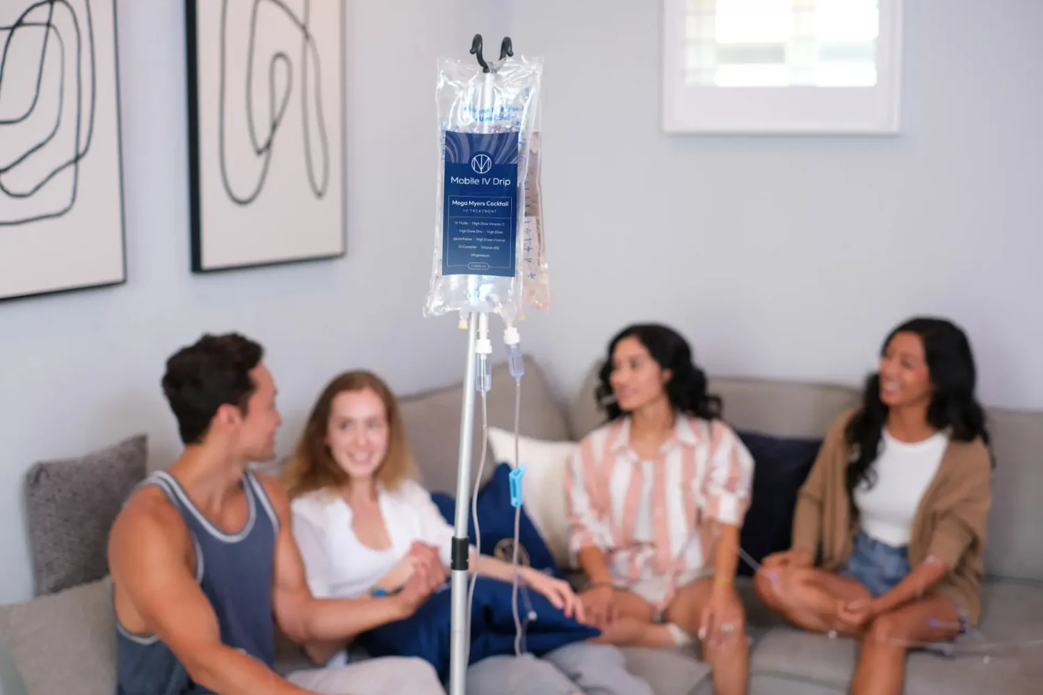 Group relaxing with mobile IV drip therapy at home.