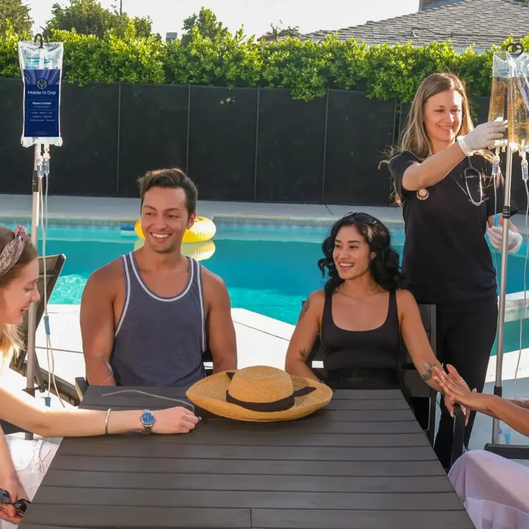 Group enjoying IV therapy by the pool