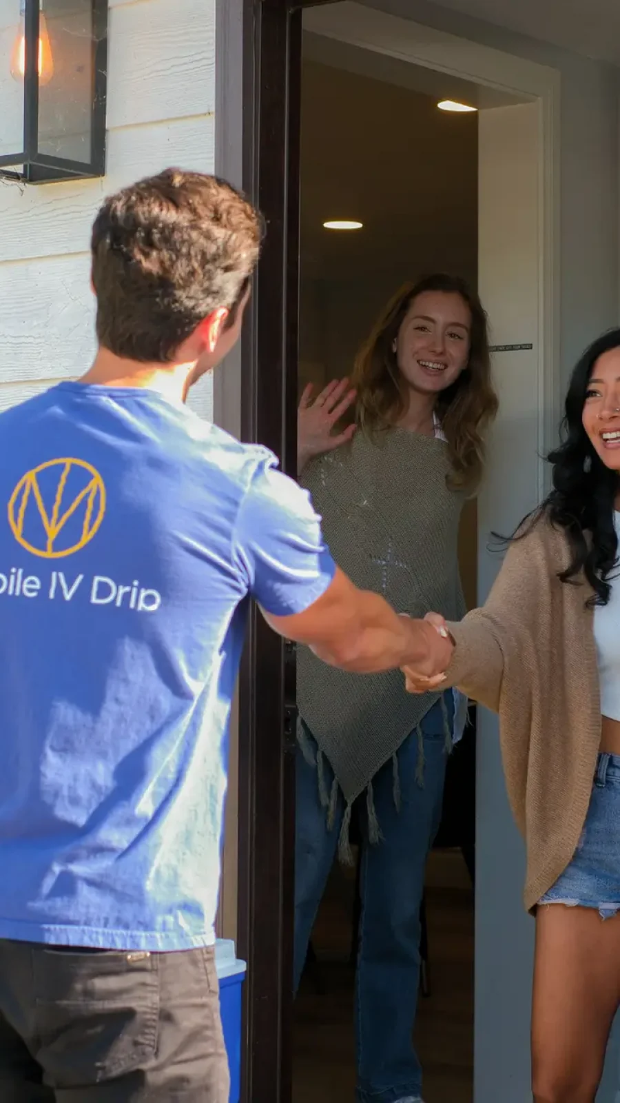 Mobile IV service provider greeting customers at home